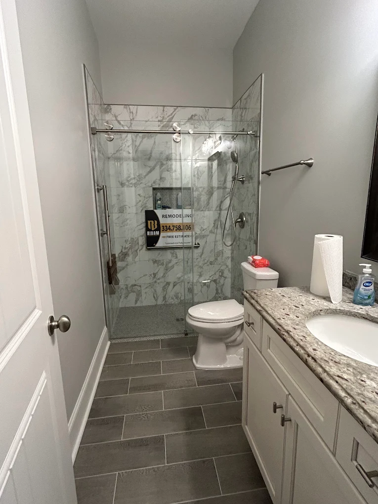 Finished bathroom remodel with a RIBAM job sign on site