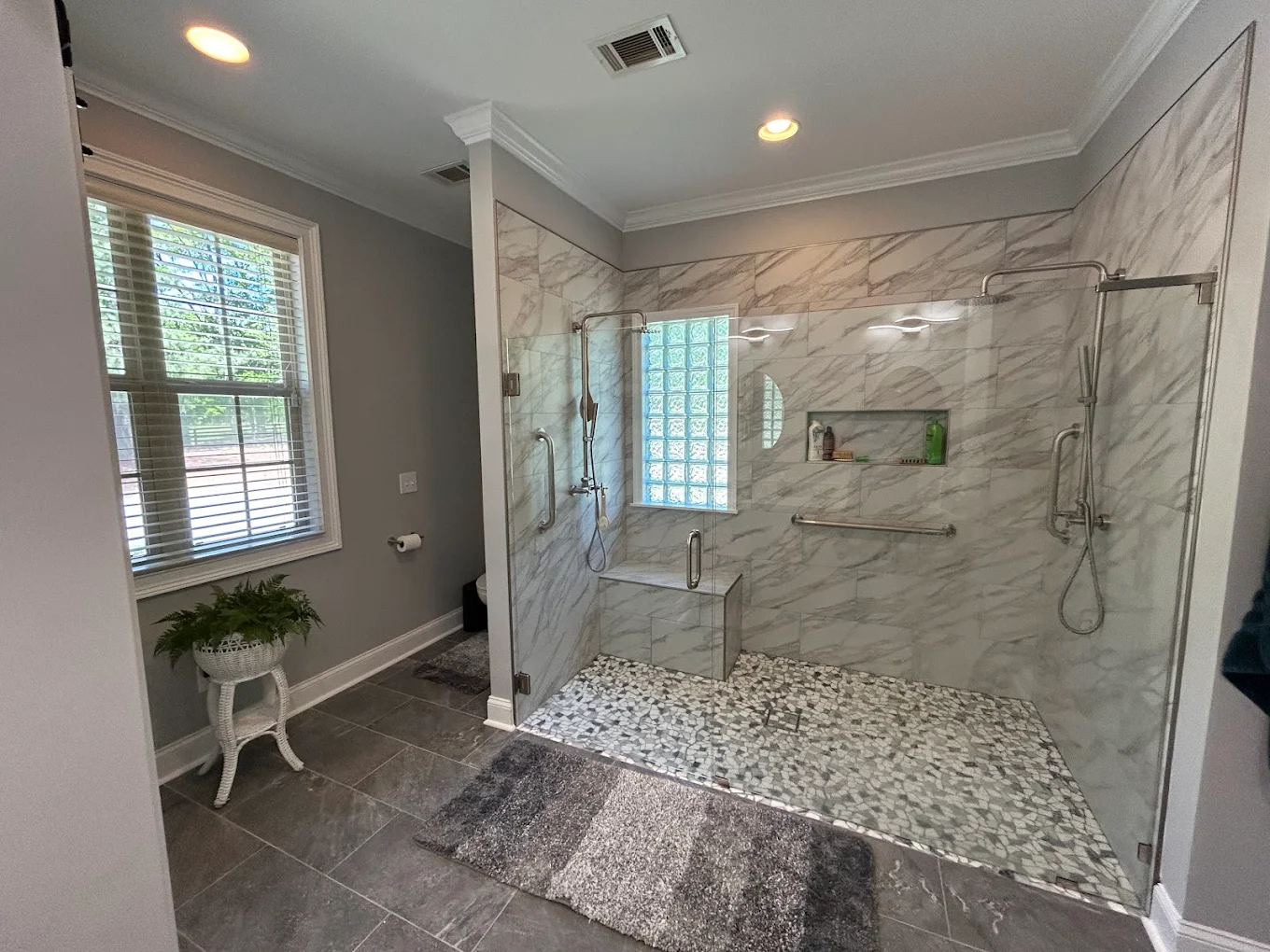 Remodeled bathroom with custom tile walk-in shower