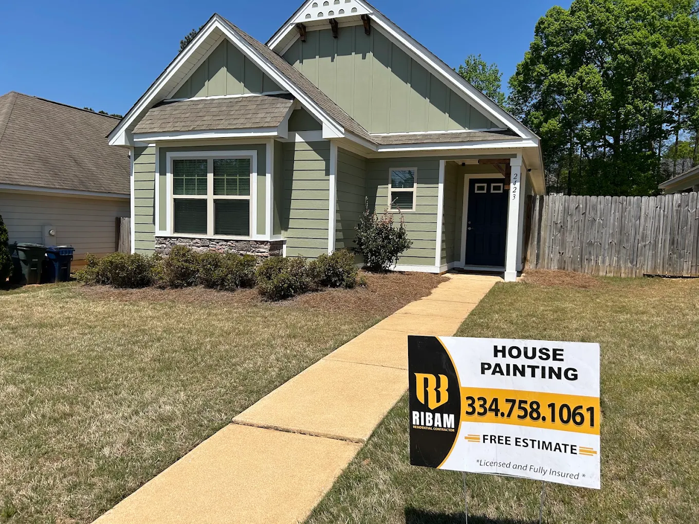 Completed house painting project with RIBAM yard sign displayed