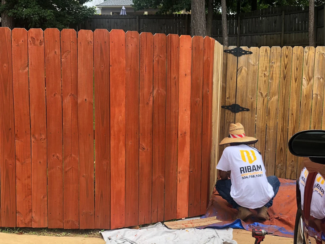 RIBAM crew staining a wood privacy fence