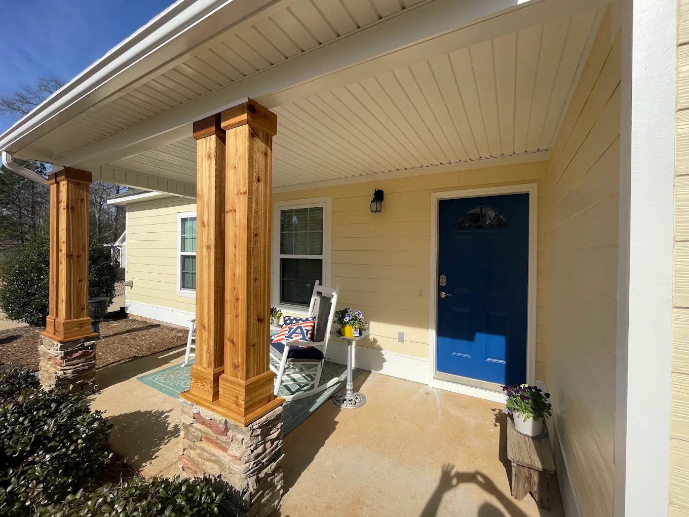Finished front porch with cedar columns and stonework