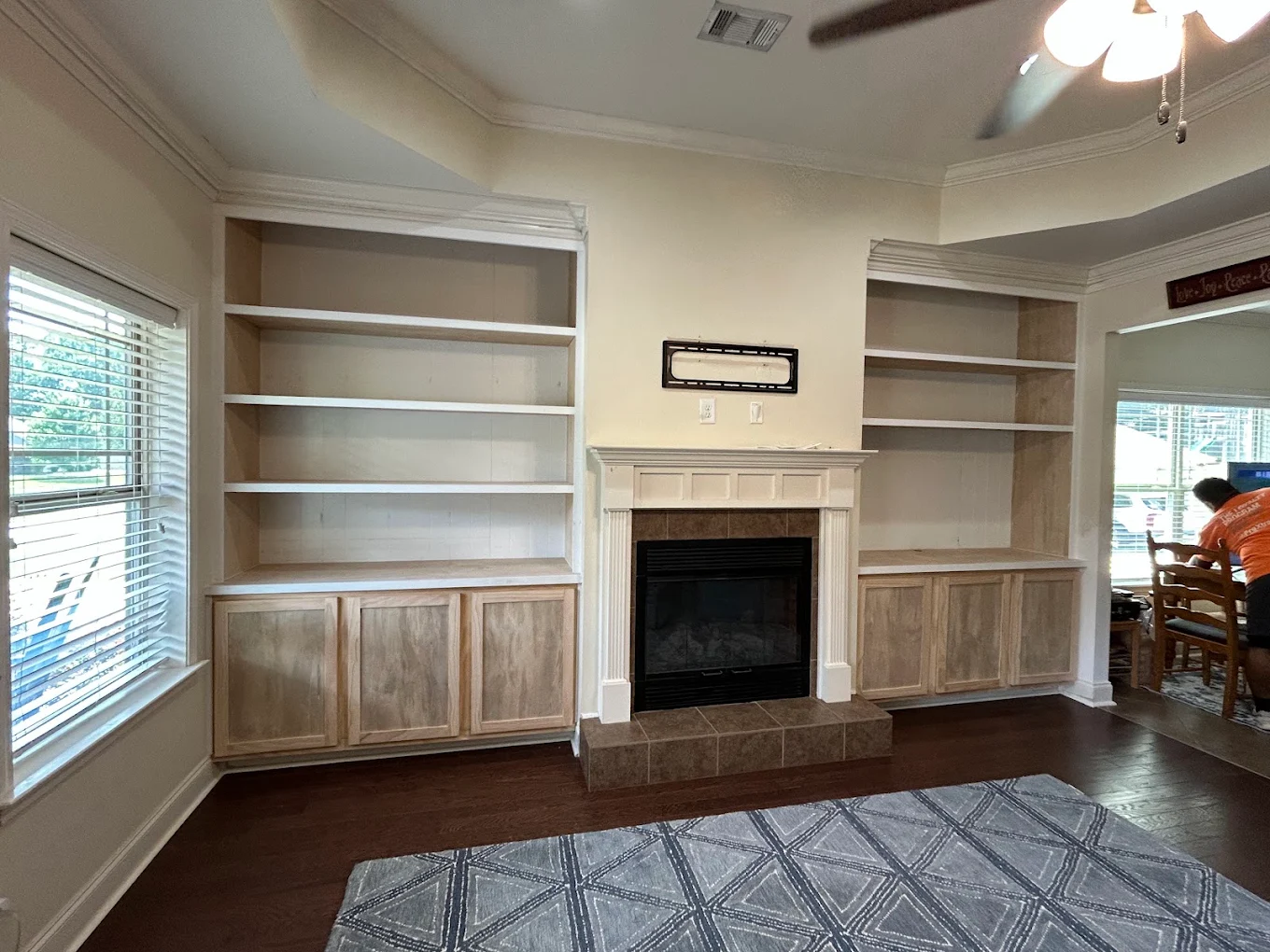 RIBAM crew finishing custom built-in shelving around a fireplace