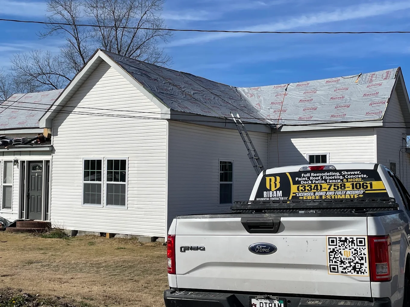 RIBAM crew re-roofing a home in Auburn, Alabama with the company truck parked on site